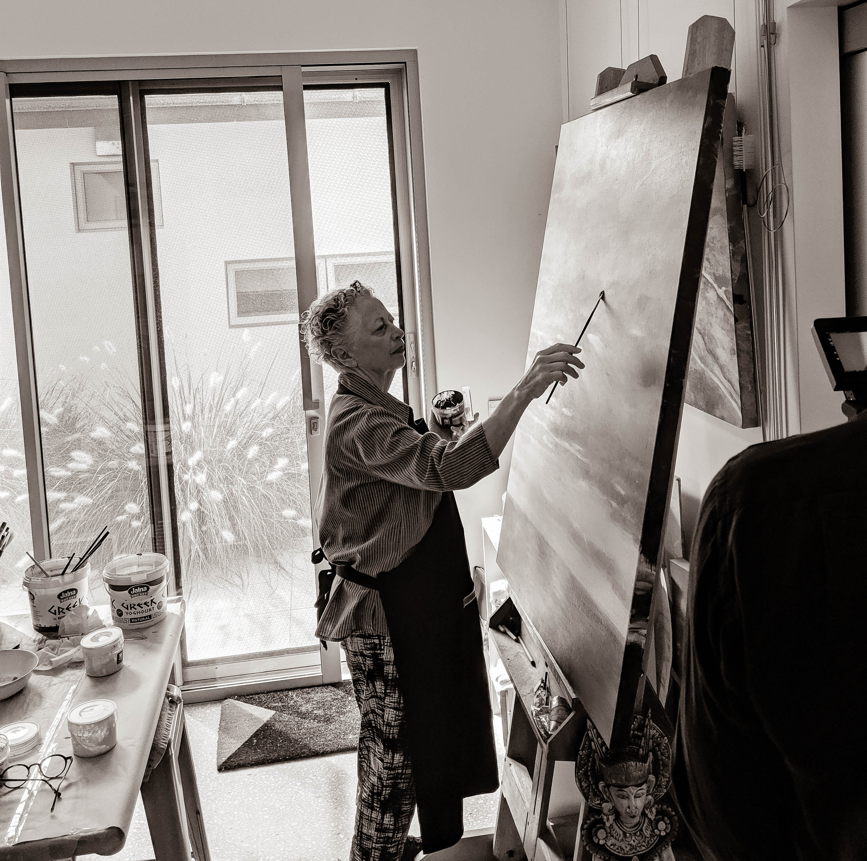 Black and white image of artist Gail Rutherford painting Cheryl's last seen image